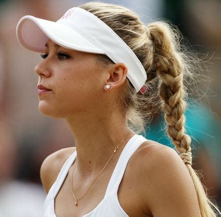 Anna Kournikova in a ponytail and white visor during ...