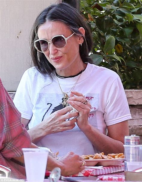Demi Moore shows off her greying locks as she meals with ...