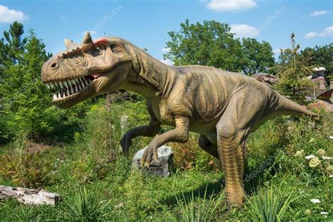 Different kind of dinosaurs in an outdoor park. Beautiful ...