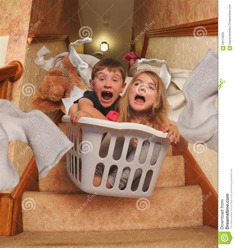 Funny Kids Riding In Laundry Basket Downstairs Stock Photo ...