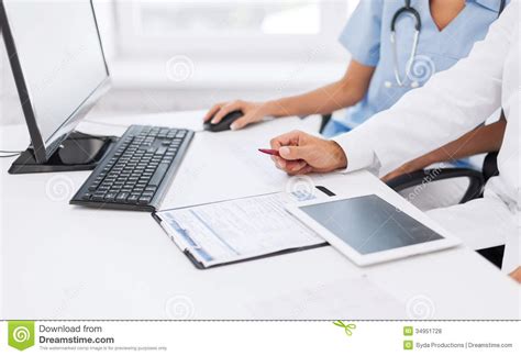 Group Of Doctors Looking At Tablet Pc Royalty Free Stock ...