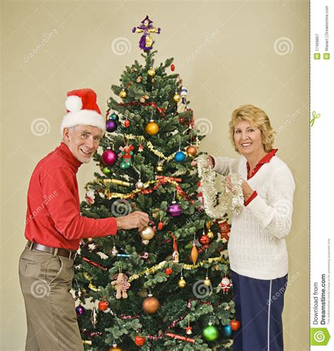 Happy Senior Couple Decorating Christmas Tree Stock Image ...