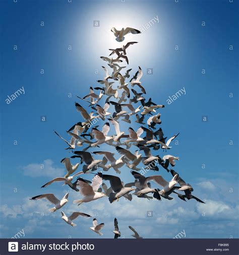 Holiday tree of hope spiritual concept as a group of birds ...