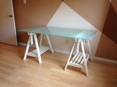 IKEA Glass desk top with adjustable white trestle legs ...