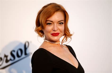 Lindsay Lohan goes demure in black and white look at amfAR ...