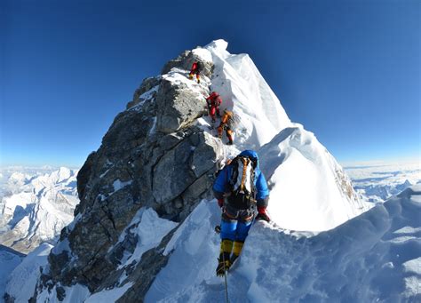 Martin Frey  in blue , Mt. Everest, Crossing the “Hillary ...