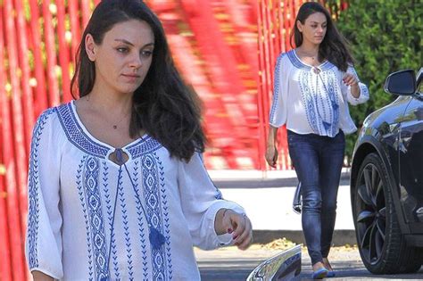 Mila Kunis covers her baby bump in a stylish blouse while ...