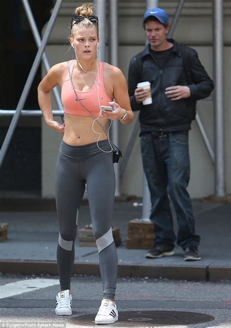 Nina Agdal exposes her derriere in ripped leggings during ...