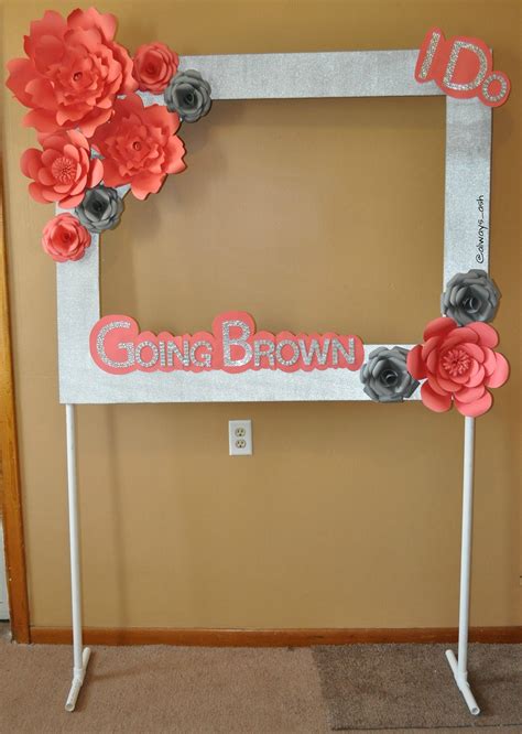 Photo booth frame with paper flowers on a pvc pipe stand ...