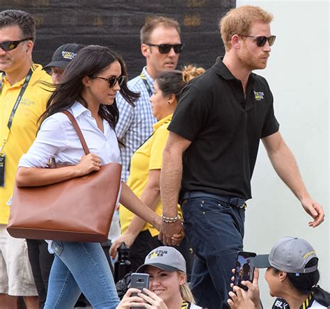 Prince Harry and Meghan Markle hold hands at Invictus Games