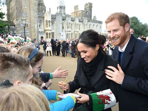 Prince Harry, Meghan Markle greeted by cheering fans in ...