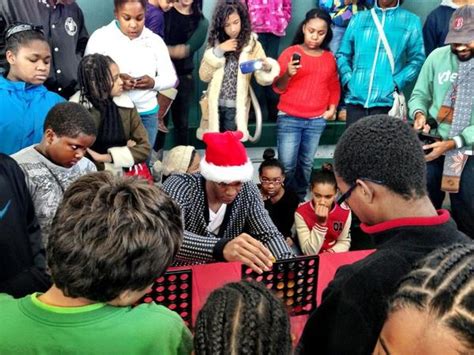 Rajon Rondo playing Connect Four with some kids ...