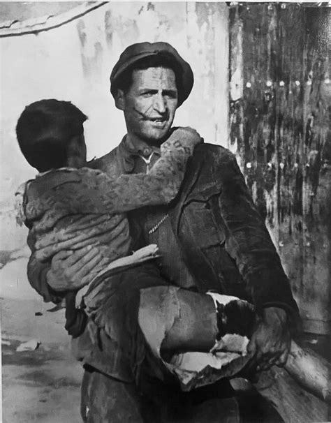 Robert Capa | Soldier carrying child, Spanish Civil War ...