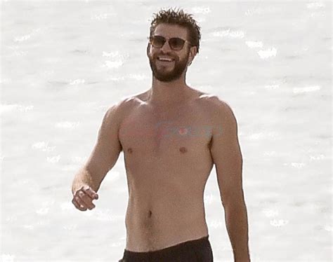 Shirtless Liam Hemsworth on the beach on Tybee Island in ...