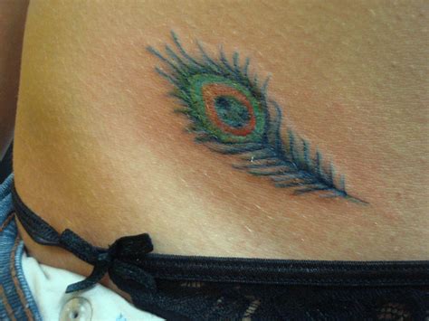 Tiny Tattoo On Hip | Tattoos.so » Small Peacock Feather ...