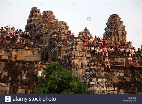 Tourists climb Phnom Bakheng Temple, Angkor Wat, Cambodia ...
