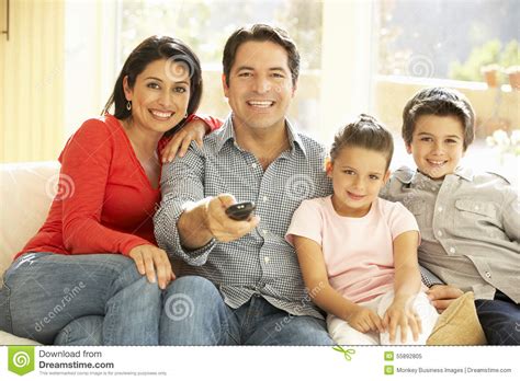 Young Hispanic Family Watching TV At Home Stock Image ...